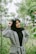 smiling woman wearing grey coat with black hijab