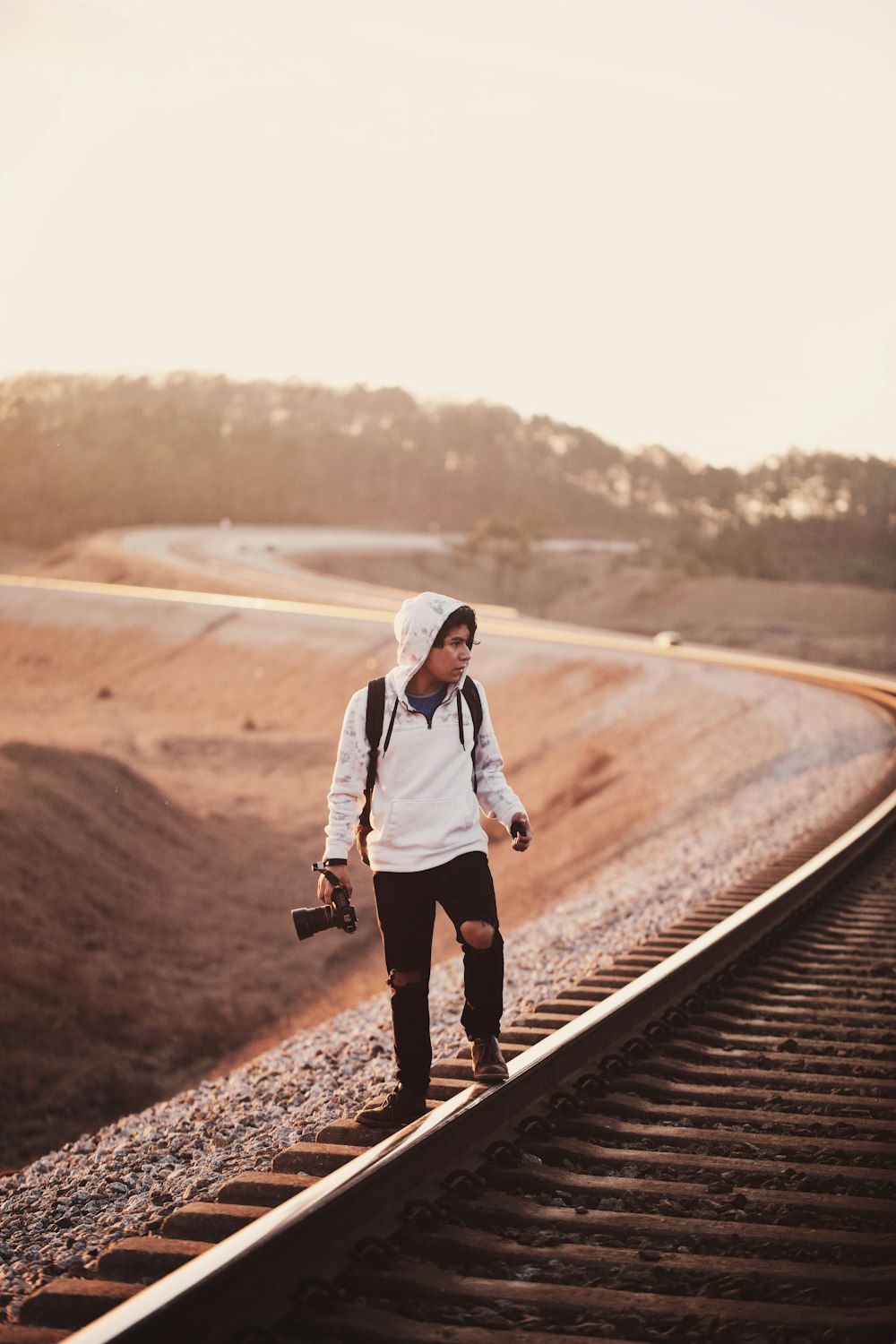 man holding black DSLR camera