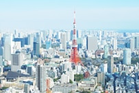 aerial photography of red tower surrounded by buildings during daytime