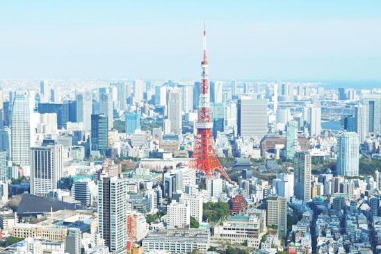 aerial photography of red tower surrounded by buildings during daytime