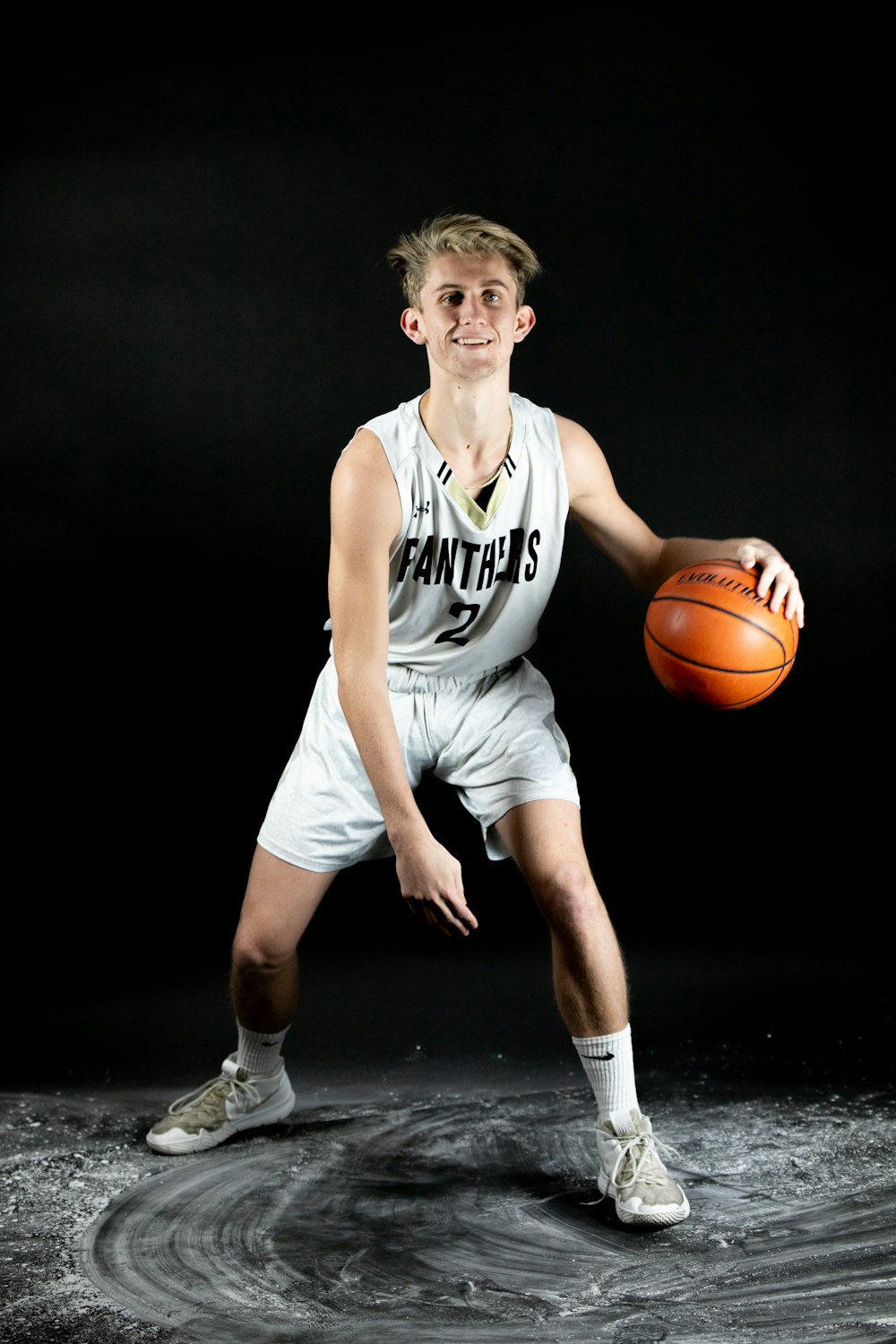 smiling man in jersey playing basketball