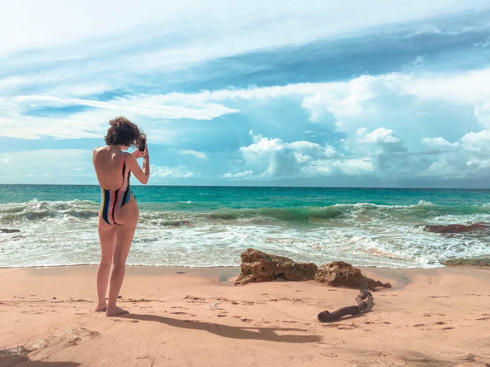 rule of thirds photography of woman standing on beach