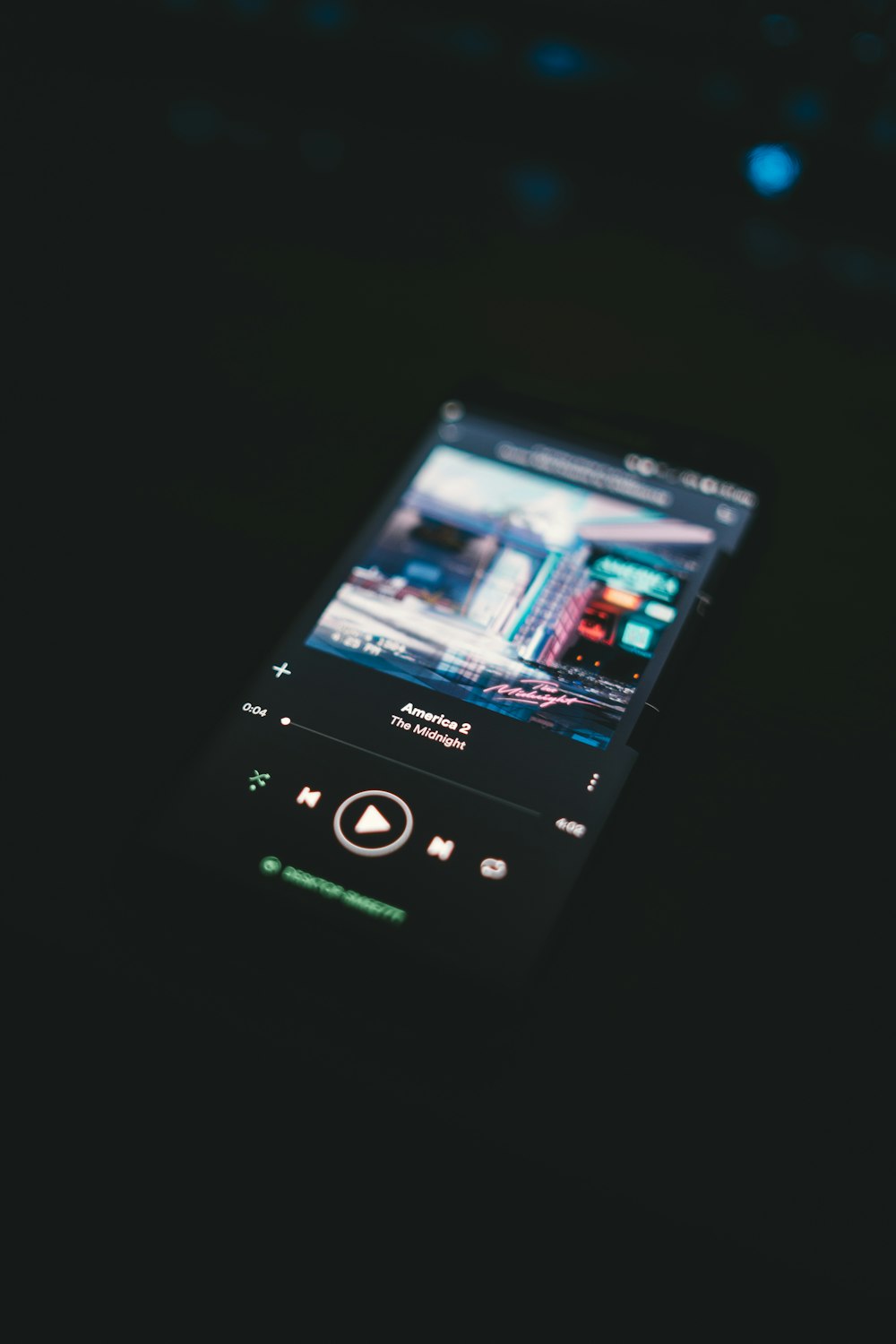 black smartphone turned-on displaying playing music