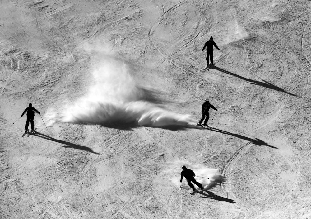 grayscale photography group of person skiing