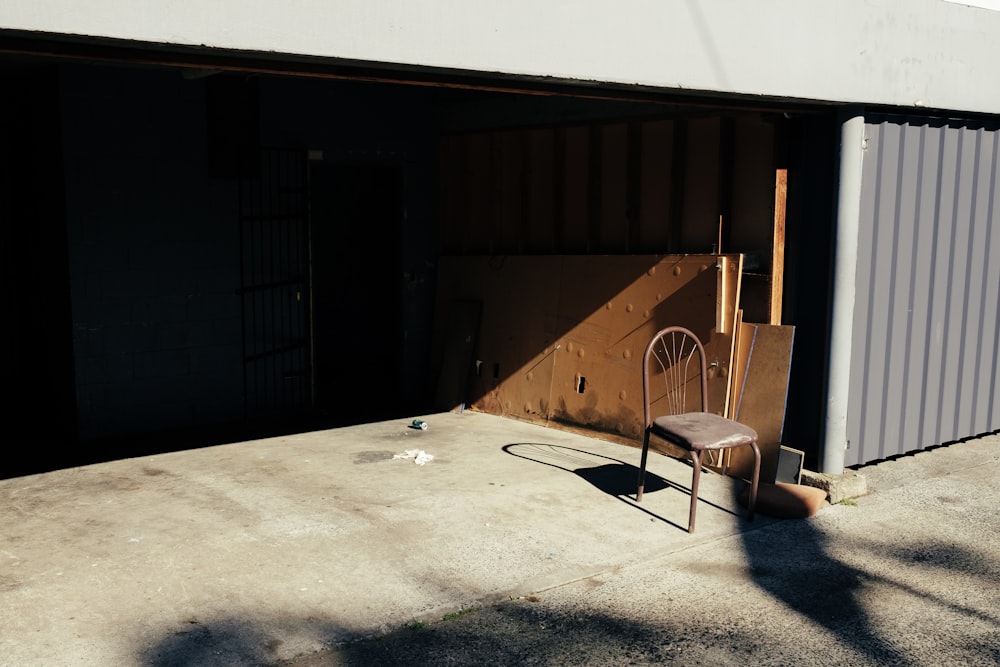brown metal armless chair on garage