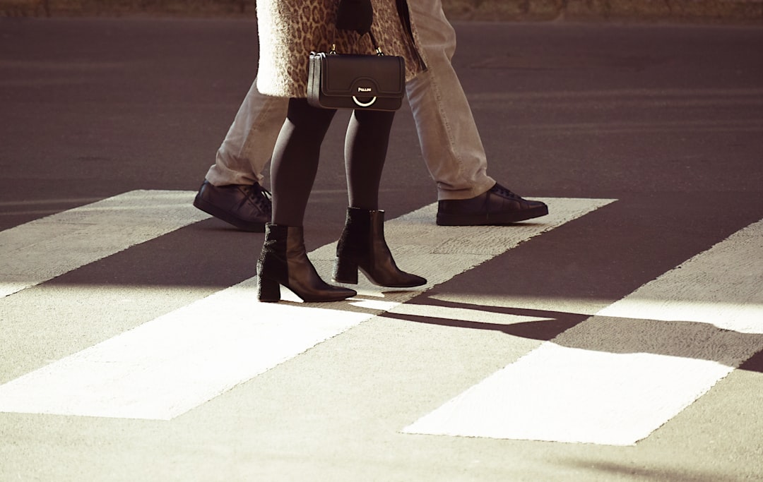 man and woman walking on pedestrian lane