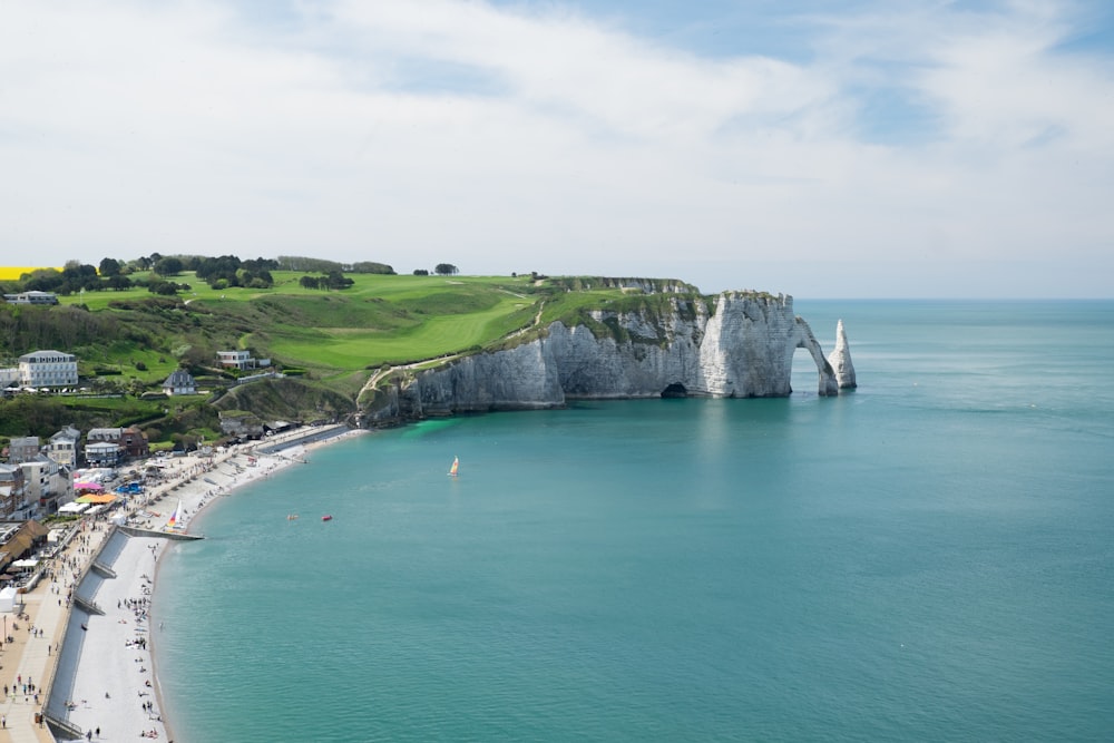 landscape photography of rock formation beside body of water