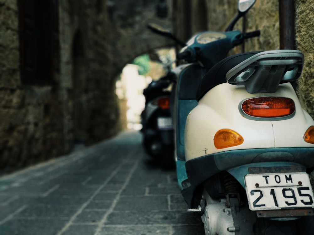 white and teal motorcycle