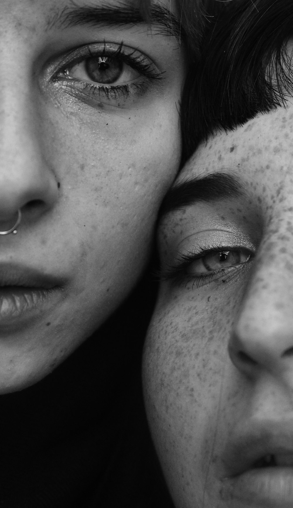 grayscale photography of two faces
