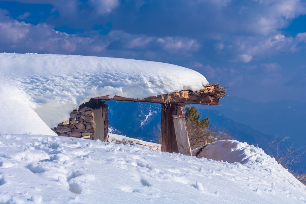 brown roof with snow covered roof under dramatic clouds during daytime