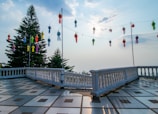 Serene outdoor terrace at moon hotel with deep blue twilight sky and golden lanterns.