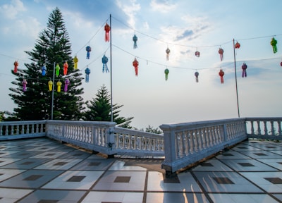 Serene outdoor terrace at moon hotel with deep blue twilight sky and golden lanterns.