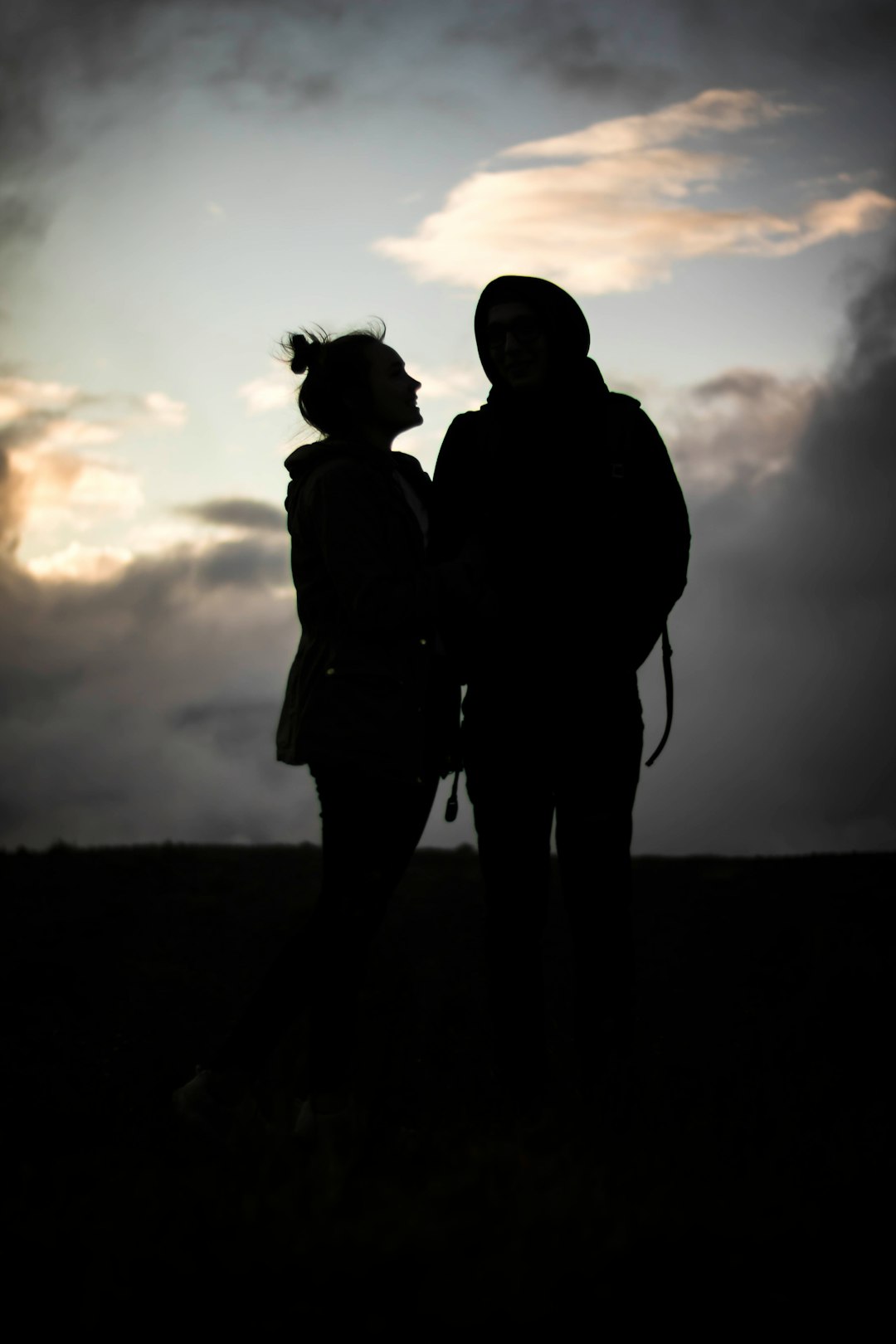 silhouette photo of two person standing