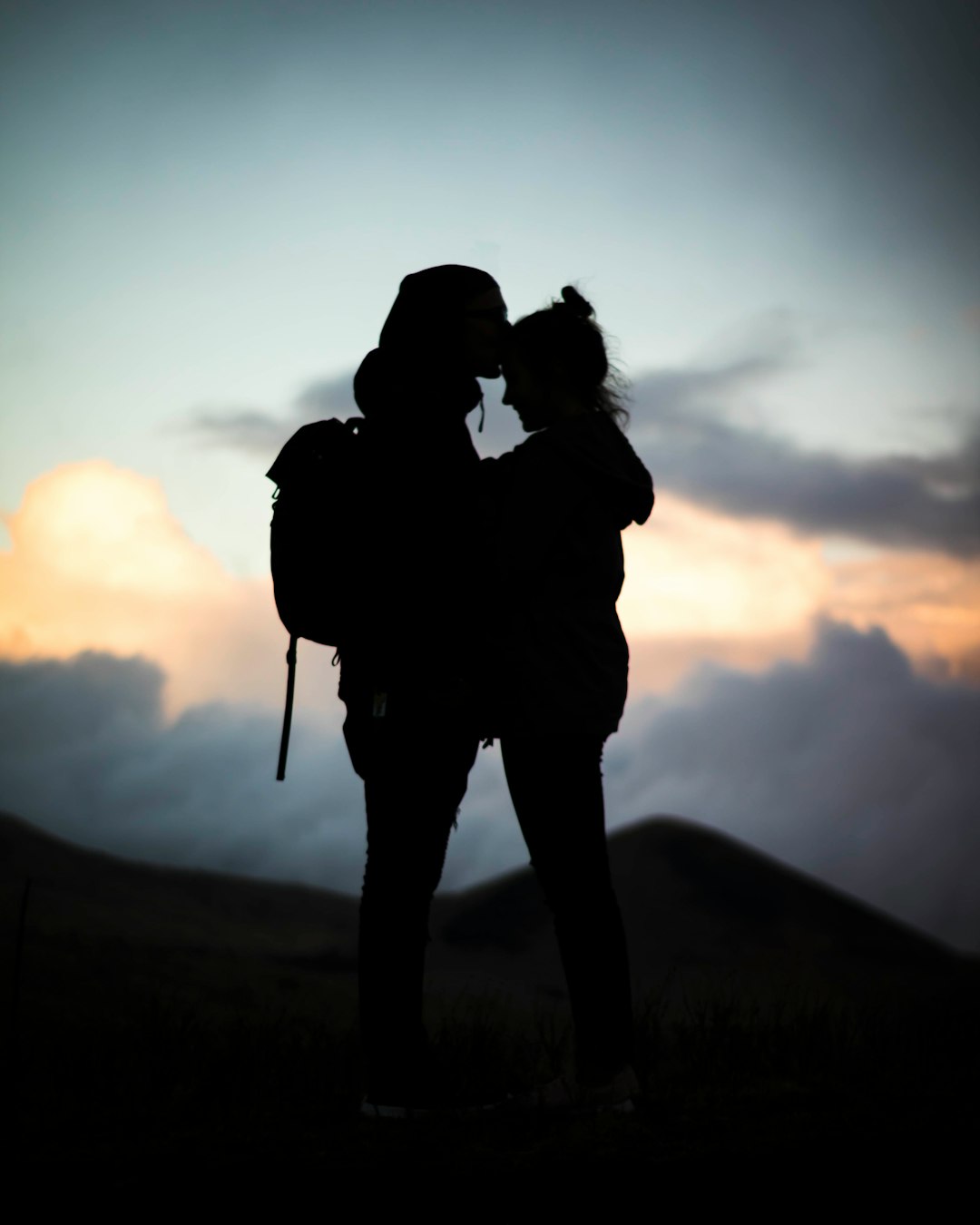 silhouette of man and woman hugging