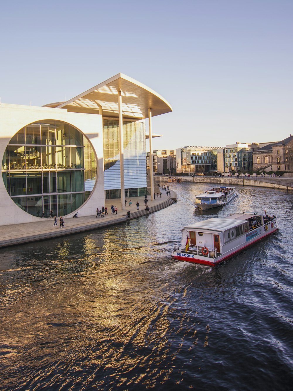 white and red boat near buildings