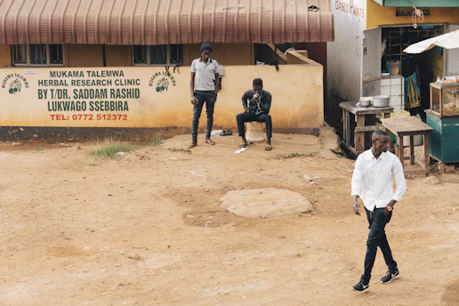 man wearing white dress shirt standing near man in white polo shirt