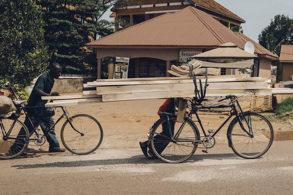 man carrying woods using bike