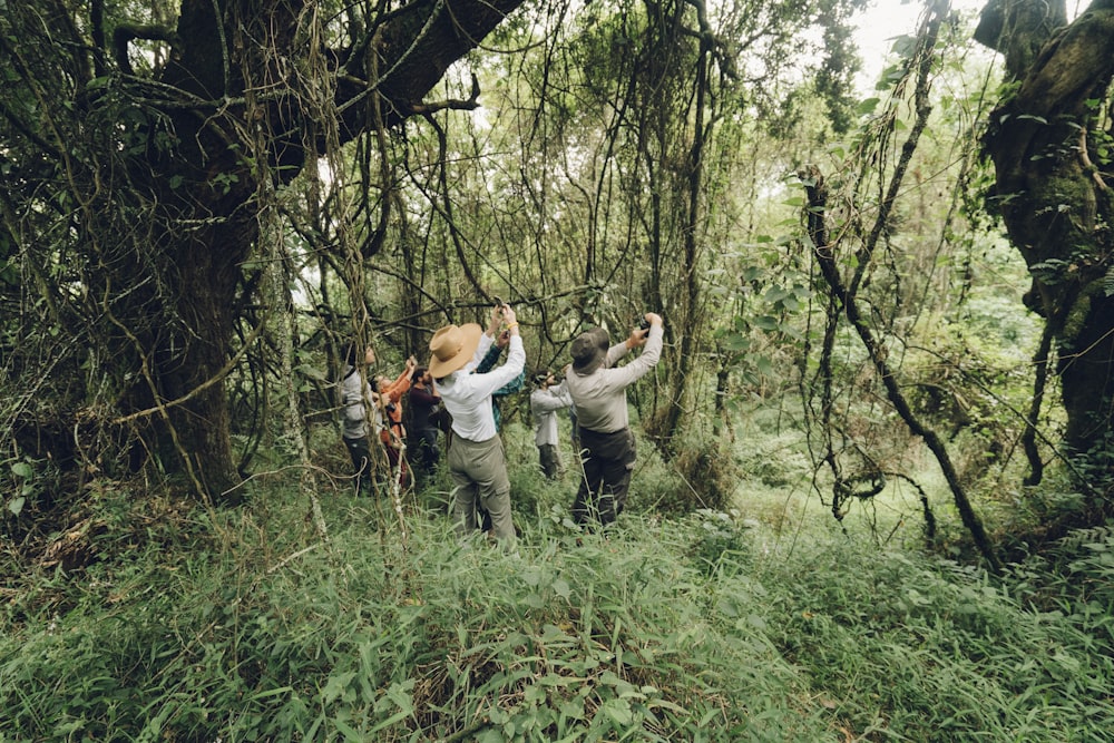 people taking photo in middle of woods