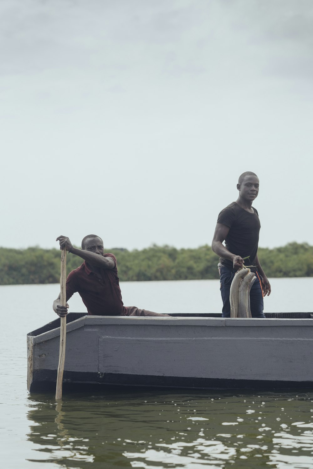 two men boating on body of water