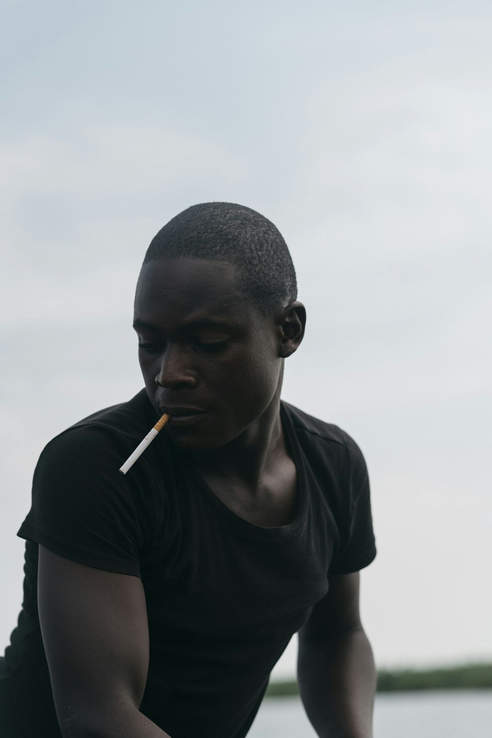 Sony a7R II + Sony FE 85mm F1.4 GM sample photo. Man smoking under white photography