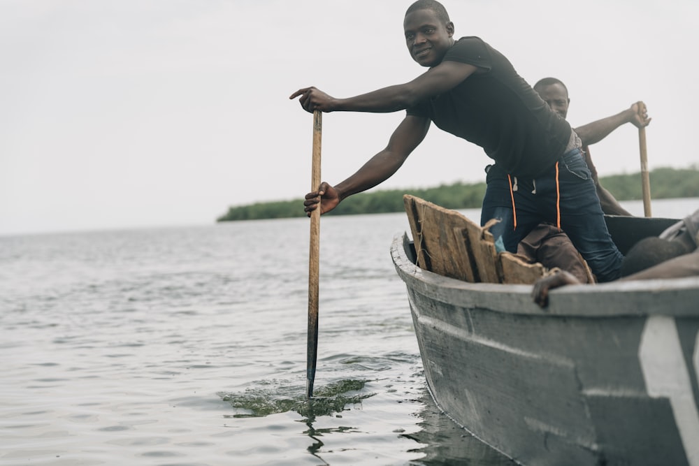 man riding on gray outboard boat