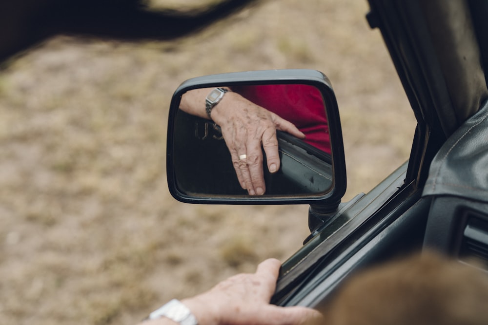 person holding car door