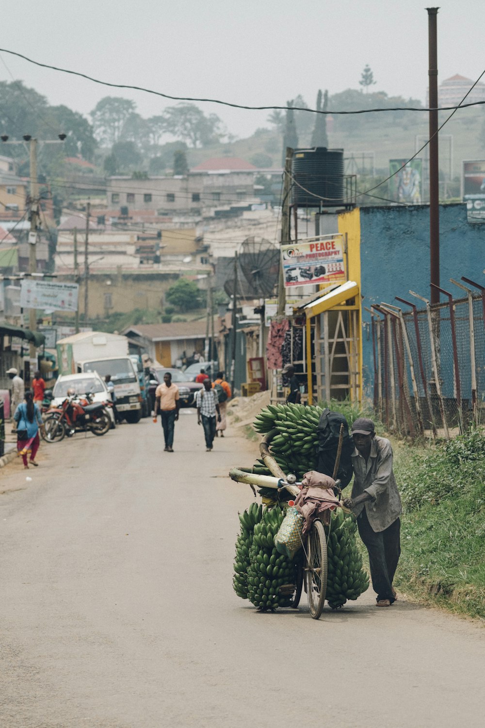 man walking beside his bicycle