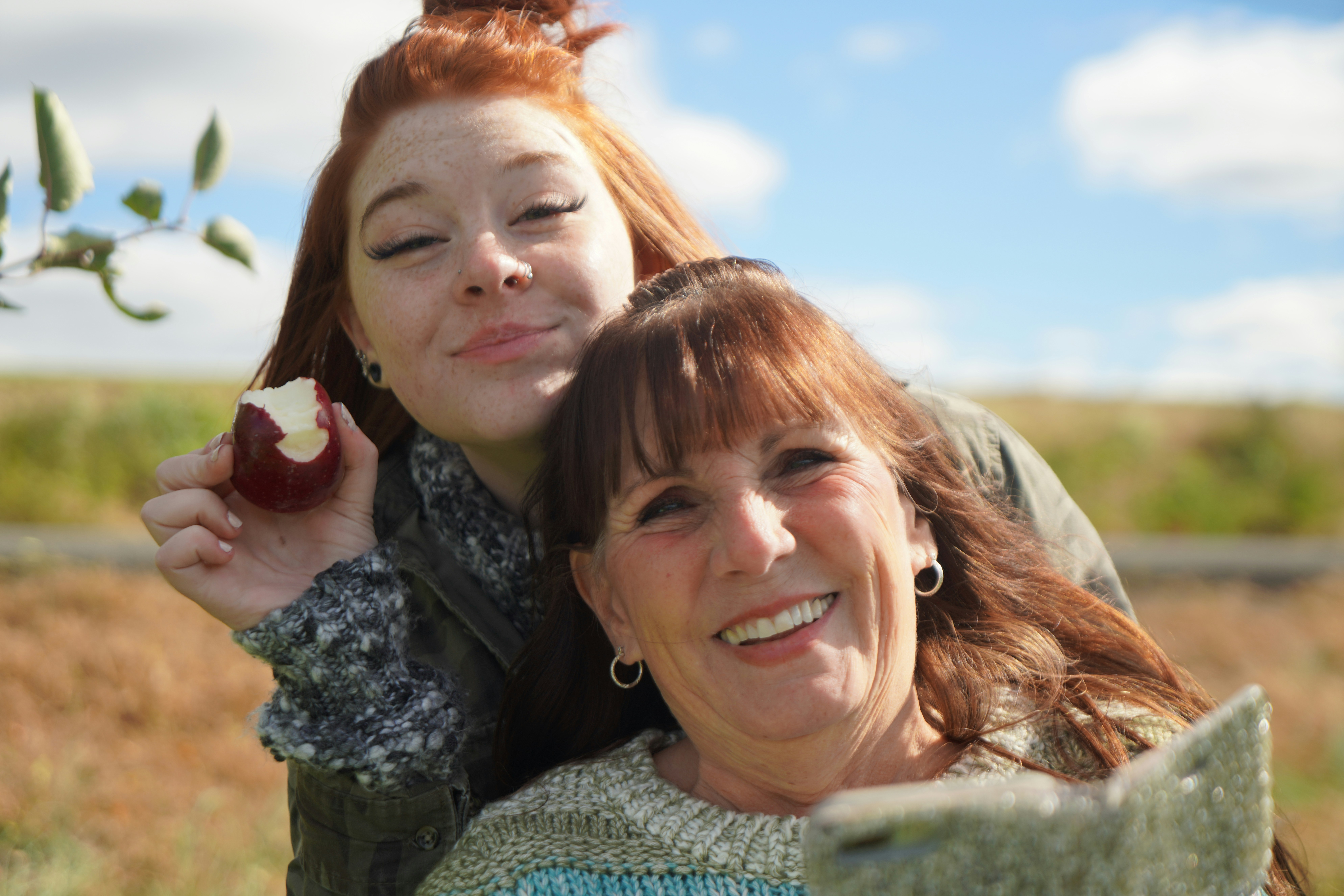 woman eating red apple outdoor