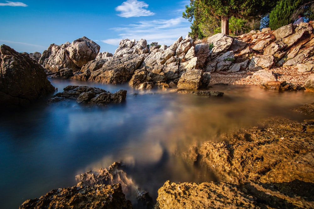 body of water and rocks