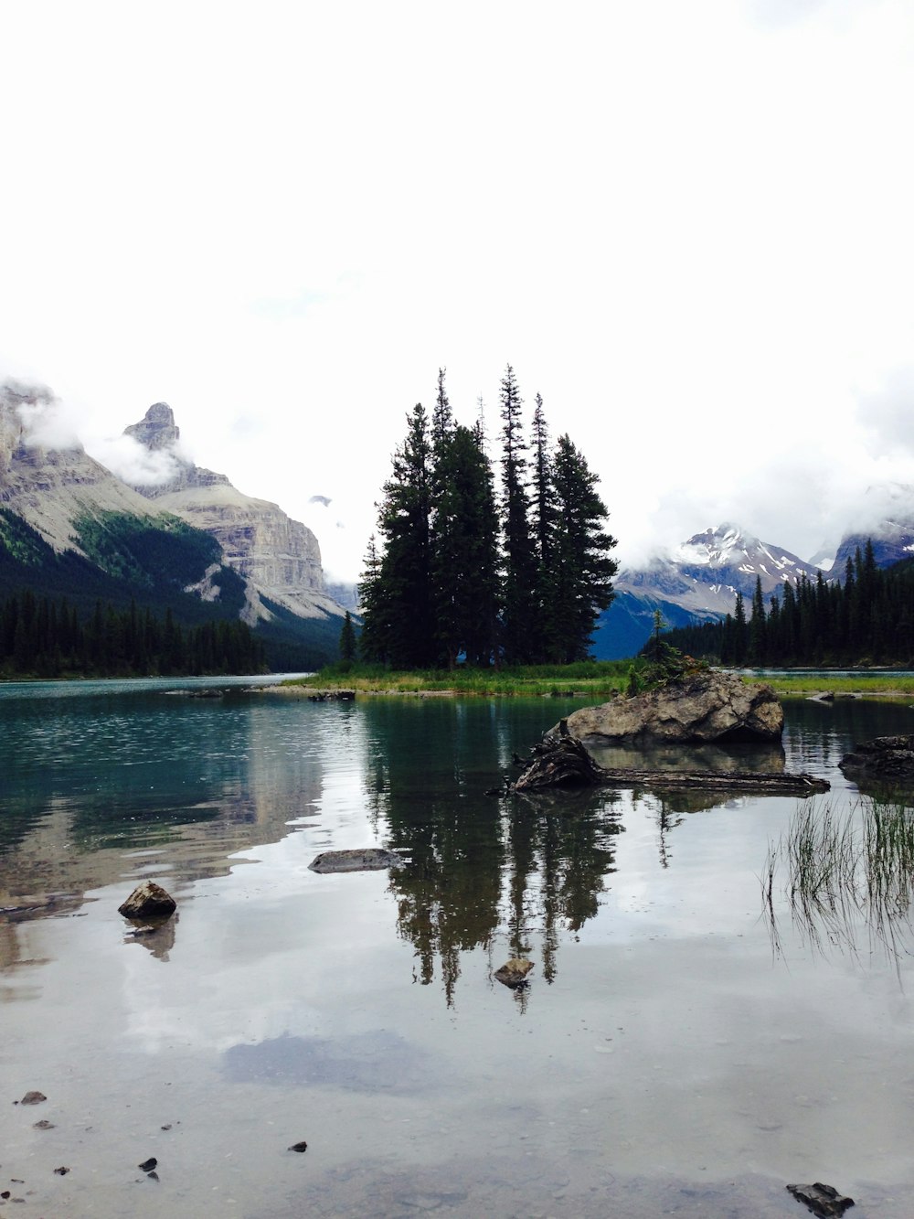 body of water under white sky