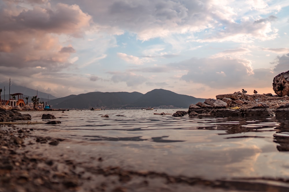 body of water under white clouds