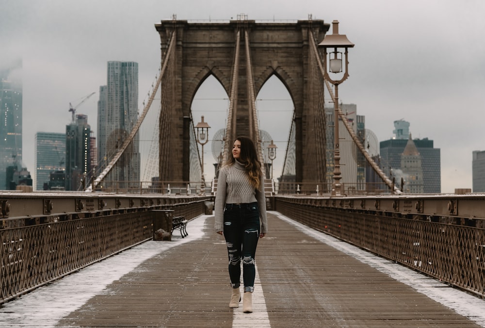 woman standing on brown steel bridge