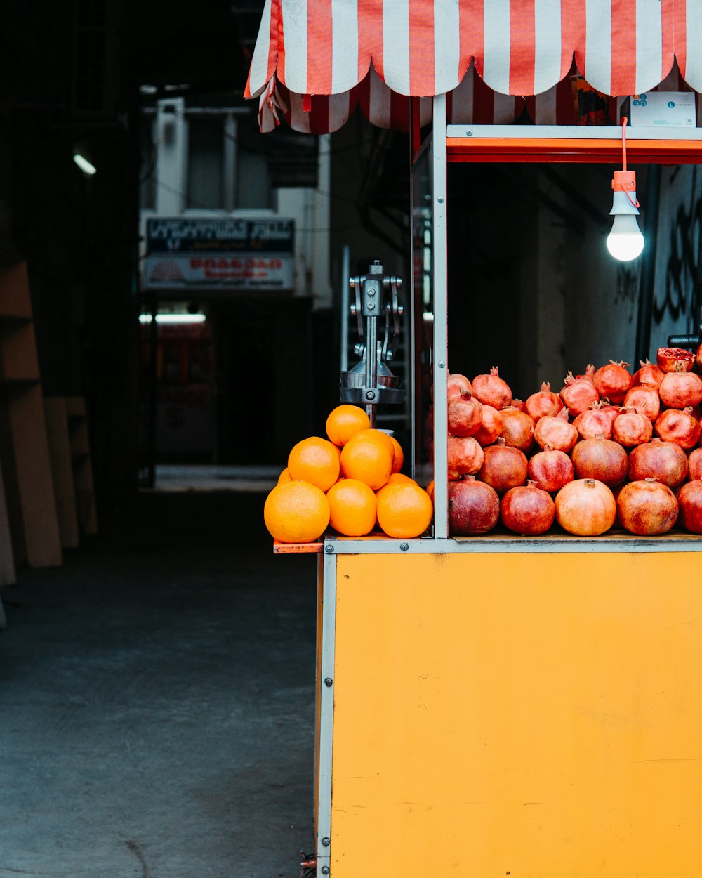 pomegranates and oranges on fruit stall
