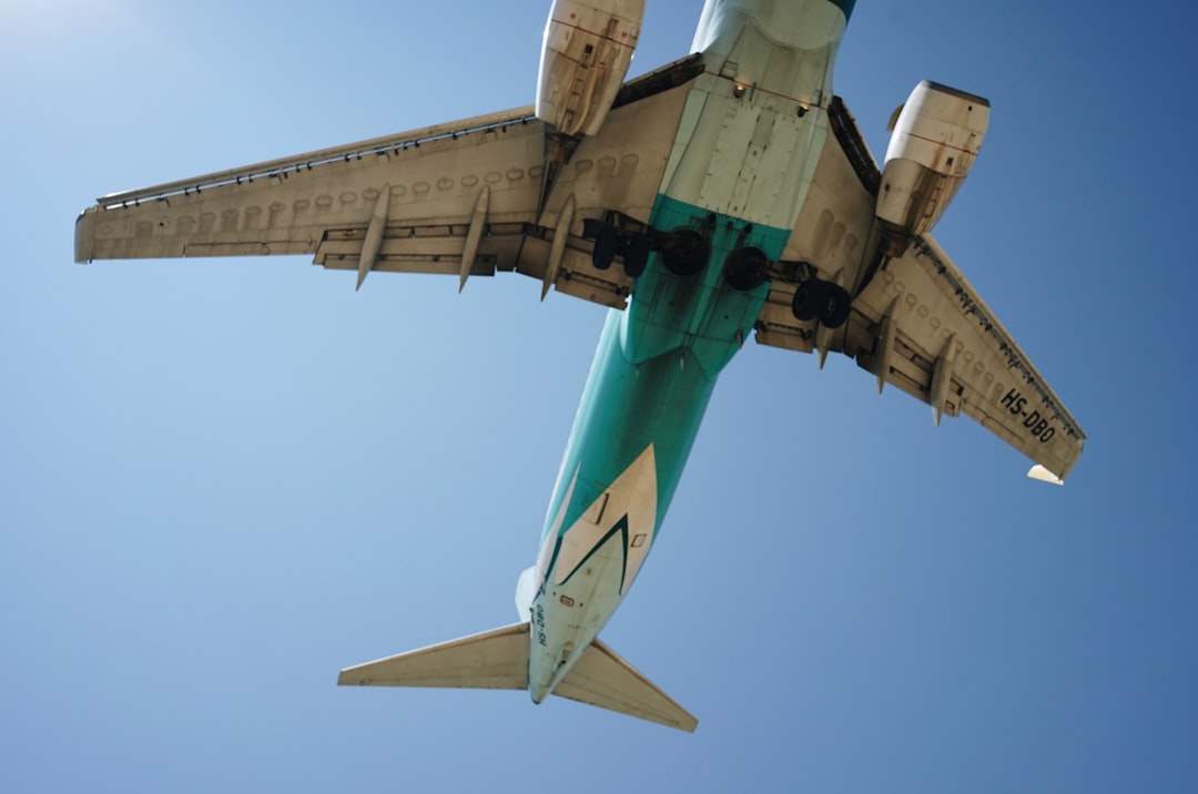 green and white airplane during daytime