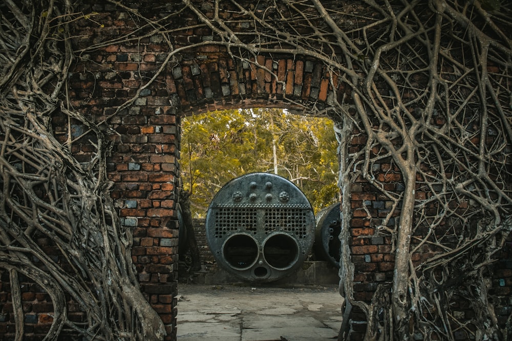 round gray metal frame beside brown concrete wall