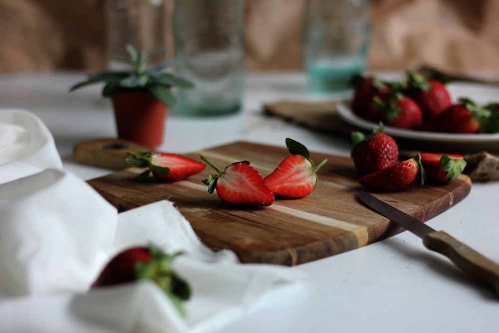 sliced strawberries on chopping board
