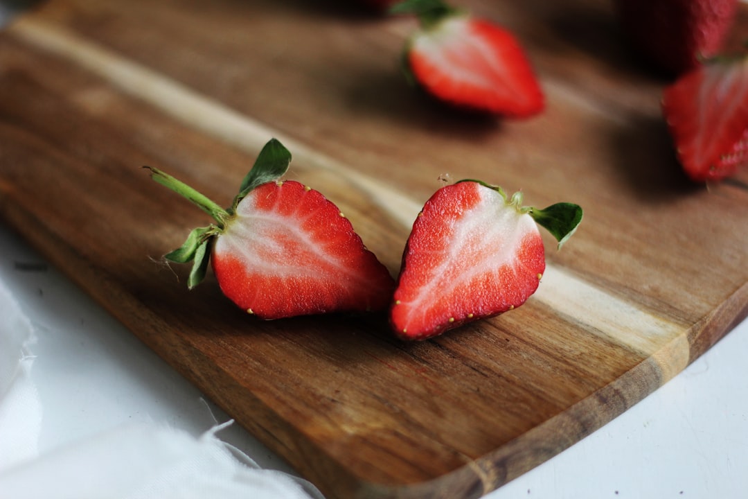 sliced of raspberry on brown wooden board