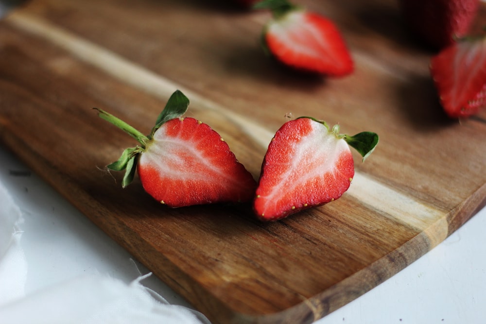 sliced of raspberry on brown wooden board