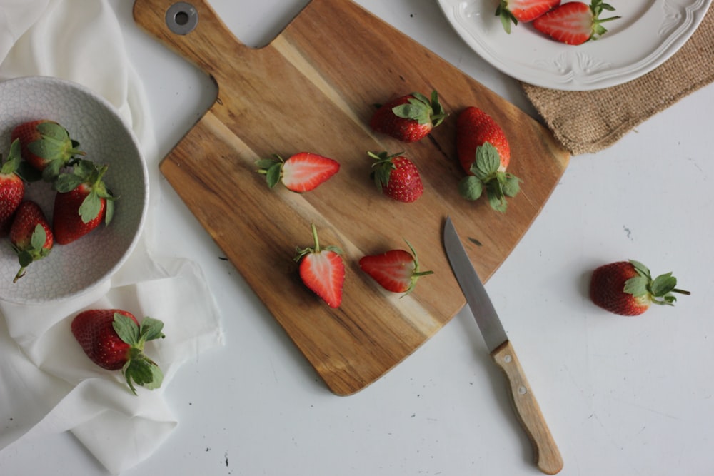 sliced strawberries on cutting board