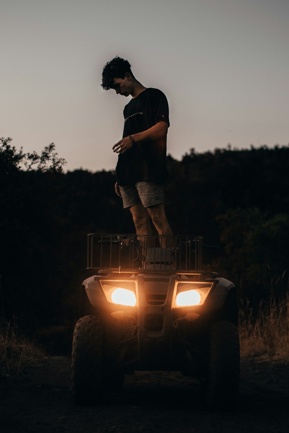 man standing on ATV
