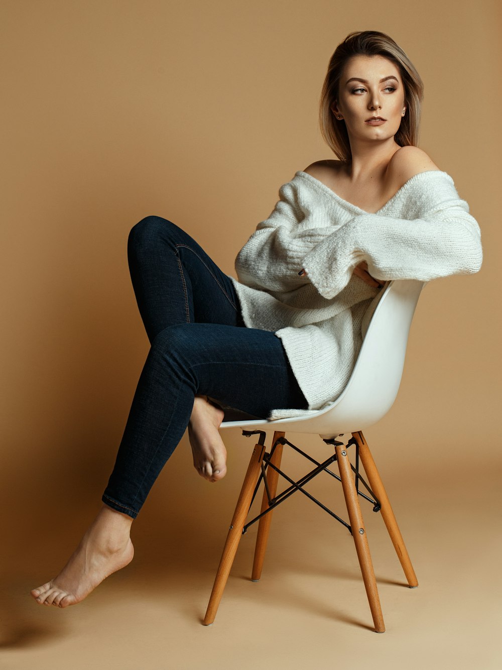 woman sitting on brown and white wooden chair