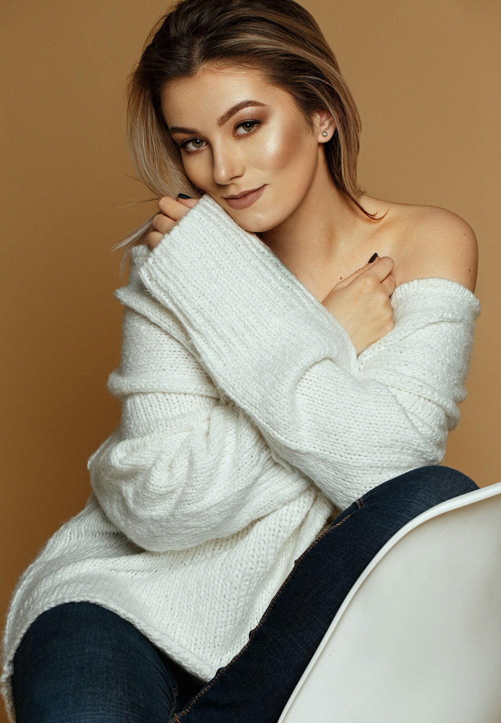 smiling woman wearing white sweater