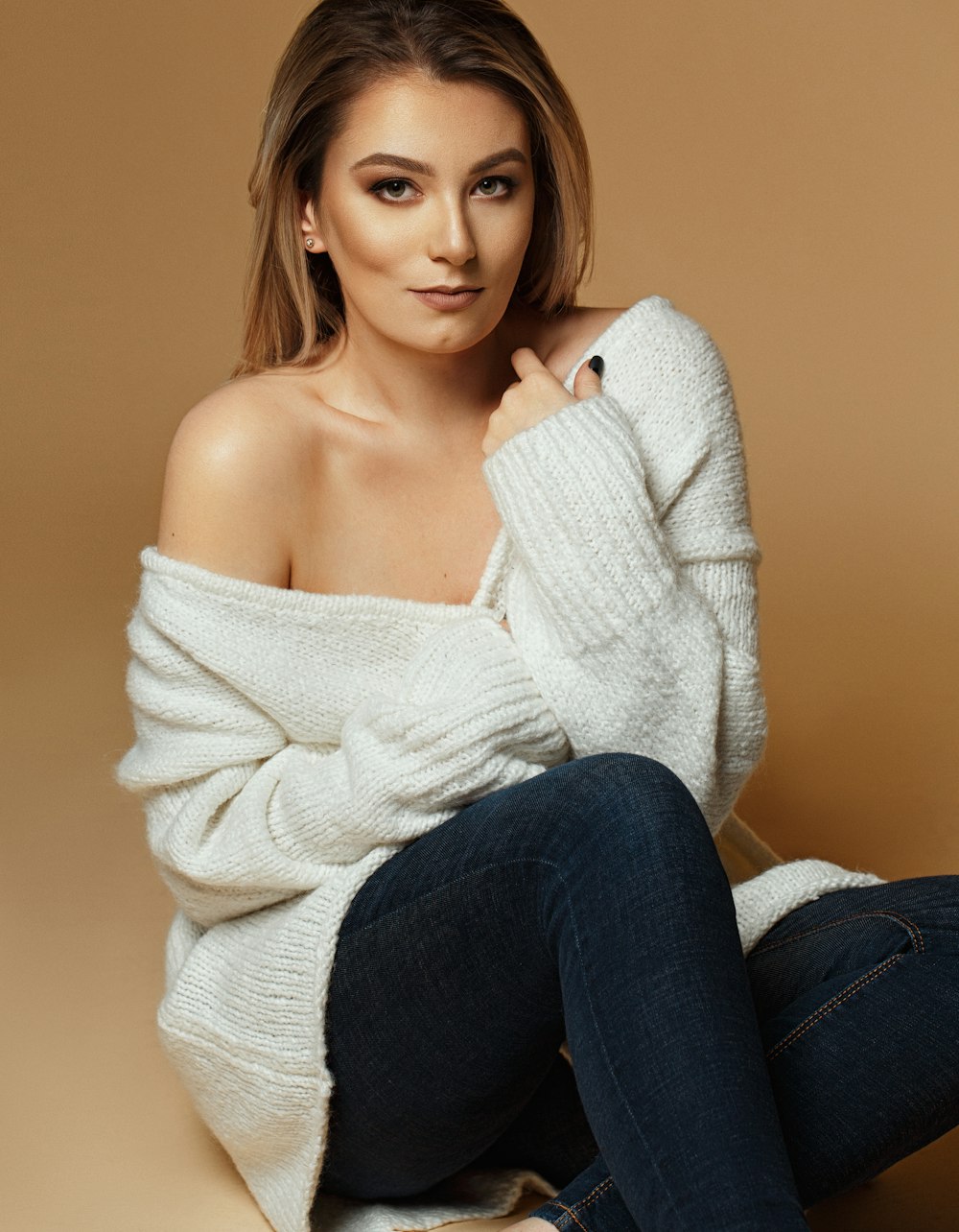 woman sitting down while posing