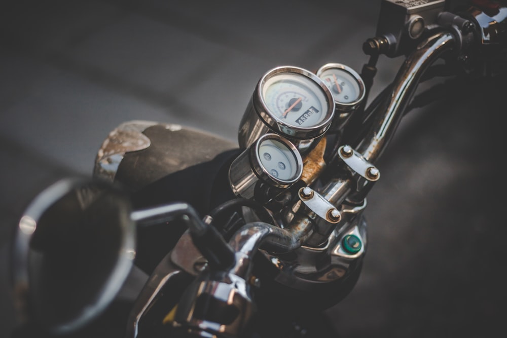shallow focus photography of motorcycle speedometer