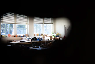 A craft room with colorful storage bags organizing art supplies and fabrics.