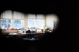 Brightly lit studio with shelves full of colorful transfer designs and crafting tools.