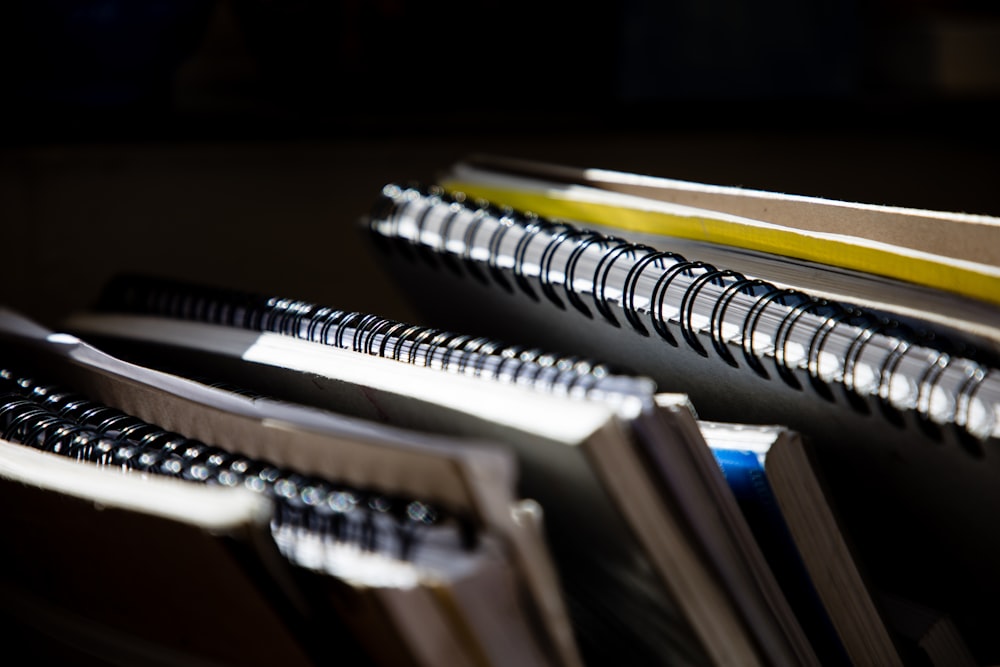 selective focus photography of spiral notebooks