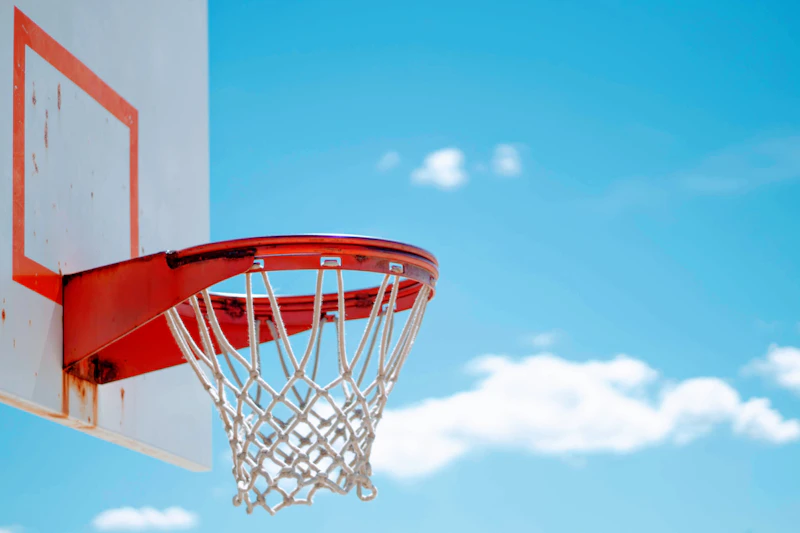 Young basketball players sitting on the court waiting to play