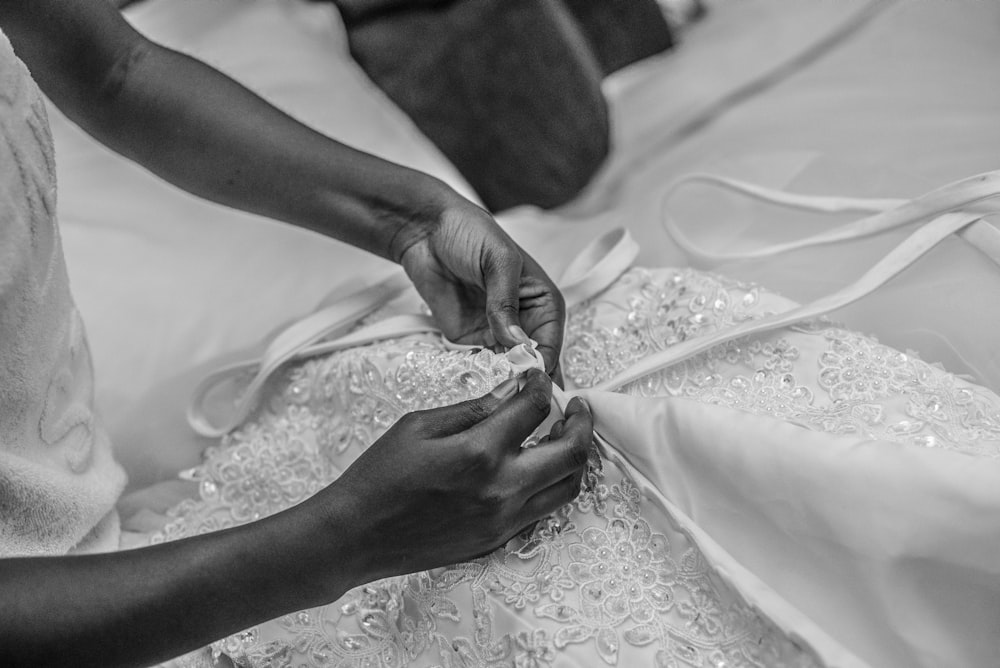 grayscale photography of person holding textile