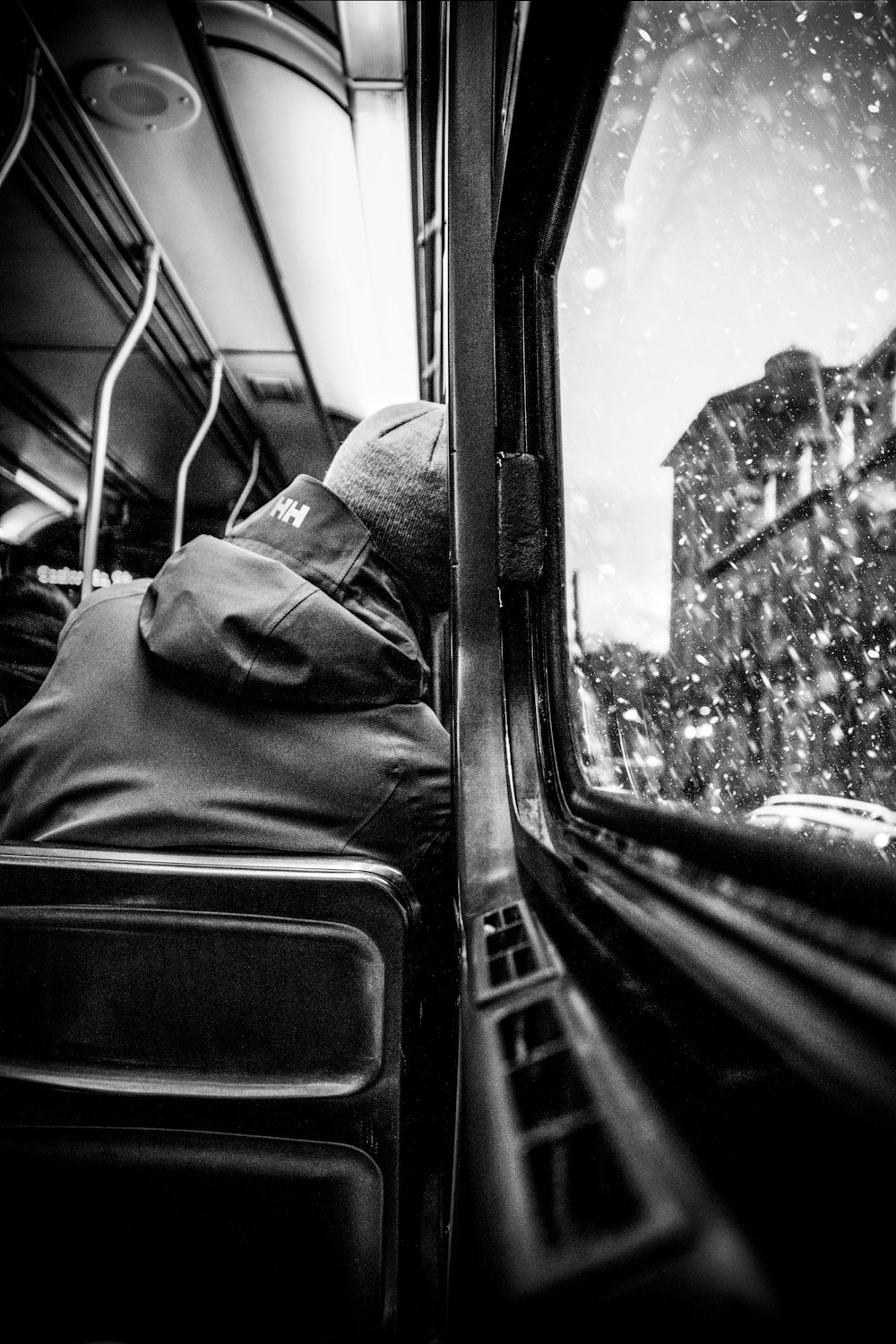 greyscale photo of person leaning on vehicle window